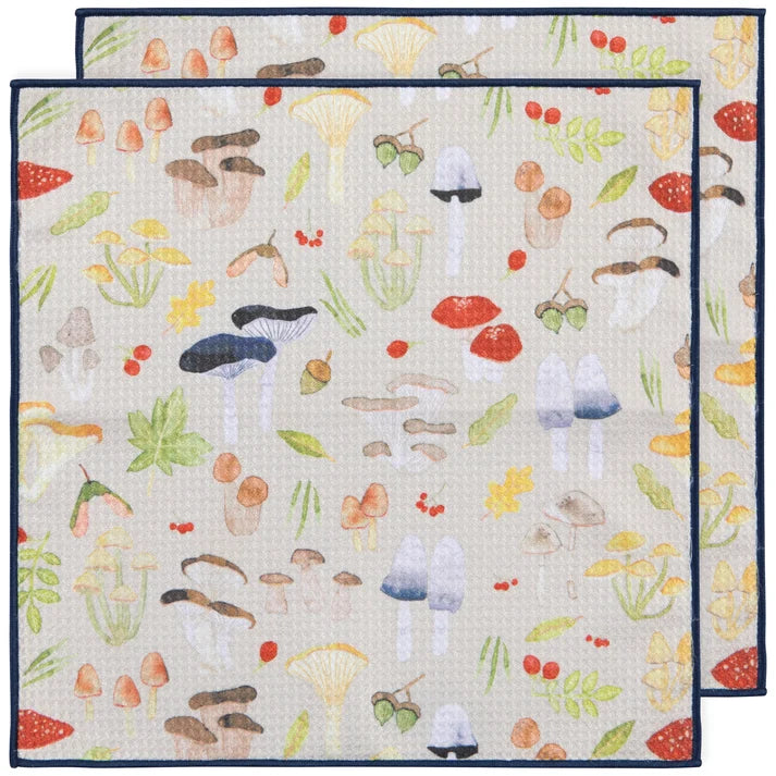 Two layered cream microfibre dishcloths printed with an all-over pattern of watercolour mushrooms and acorns – PABOOM