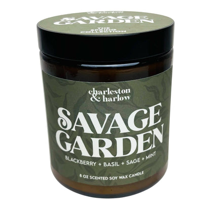 Charleston & Harlow Savage Garden soy candle in amber glass jar with dark olive green striped label and black lid