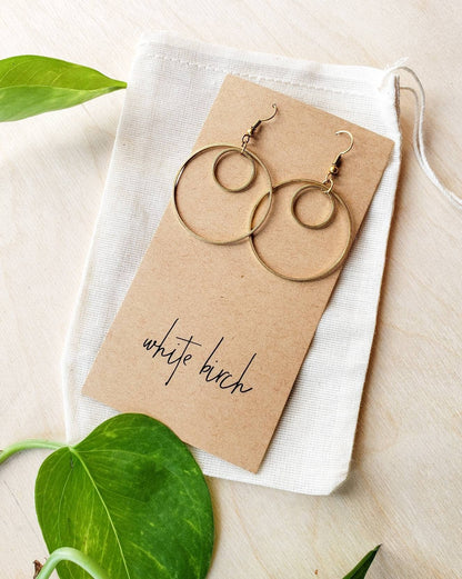 Model wearing brass double circle earrings