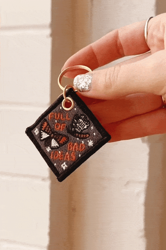 Full of Bad Ideas Keychain shown attached to keys