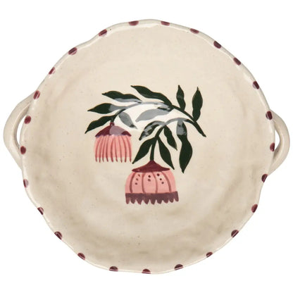 Ceramic dish with floral design and handles on a white background