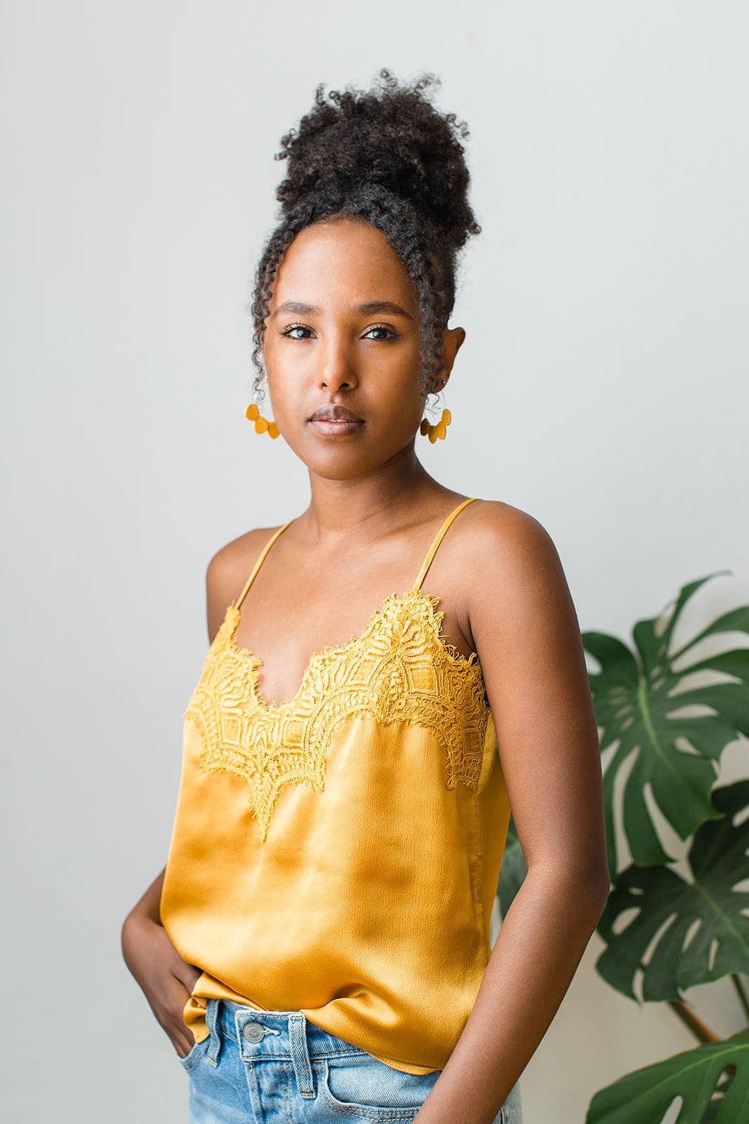 Mustard yellow leather petal hoop earrings shown in silver, rose gold, and yellow gold finishes