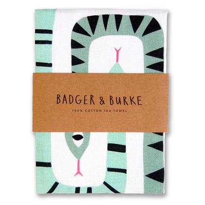 Folded cotton tea towel printed with striped mint and sage snakes with pink tongues, Badger + Burke kraft band - PABOOM