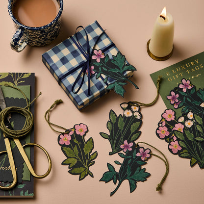 Botanical gift tags shown individually tied onto a wrapped present