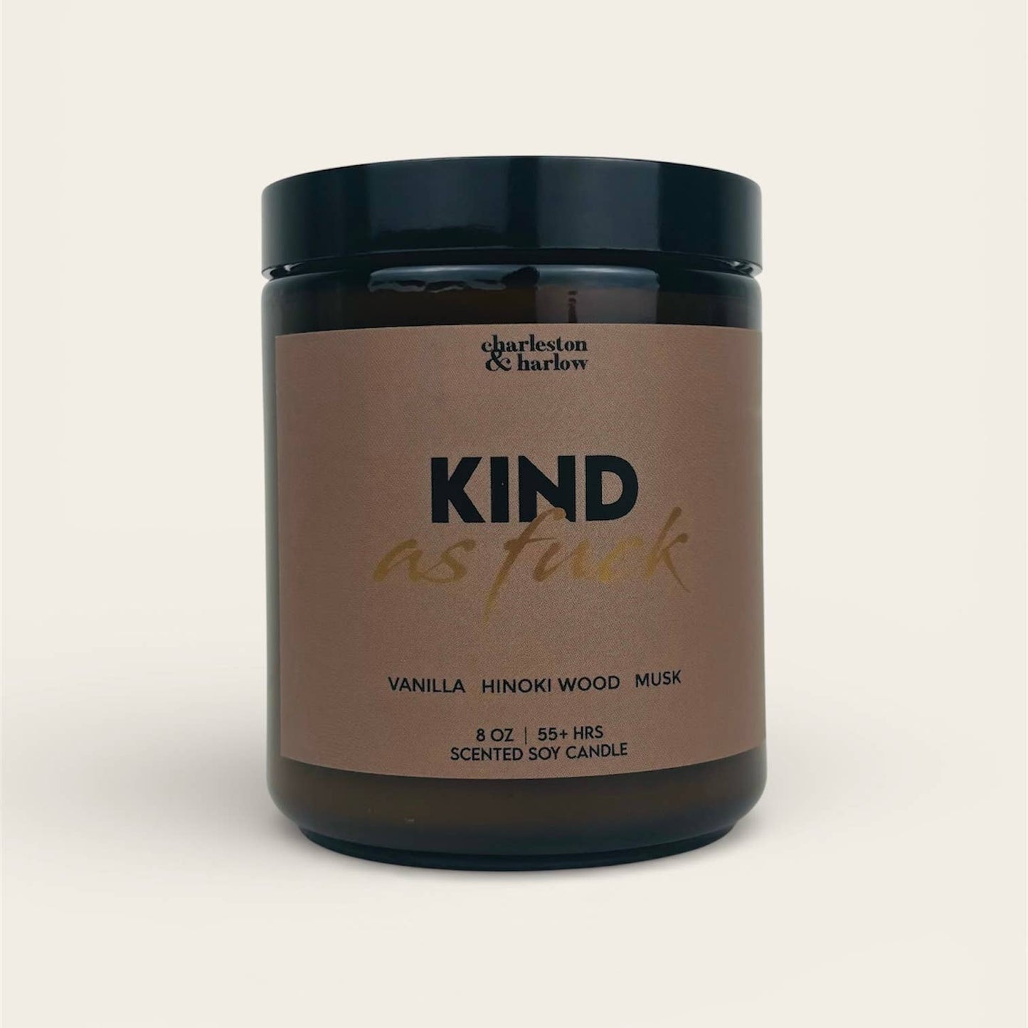 Charleston & Harlow Kind As Fuck soy candle in amber glass jar with warm brown label and gold script