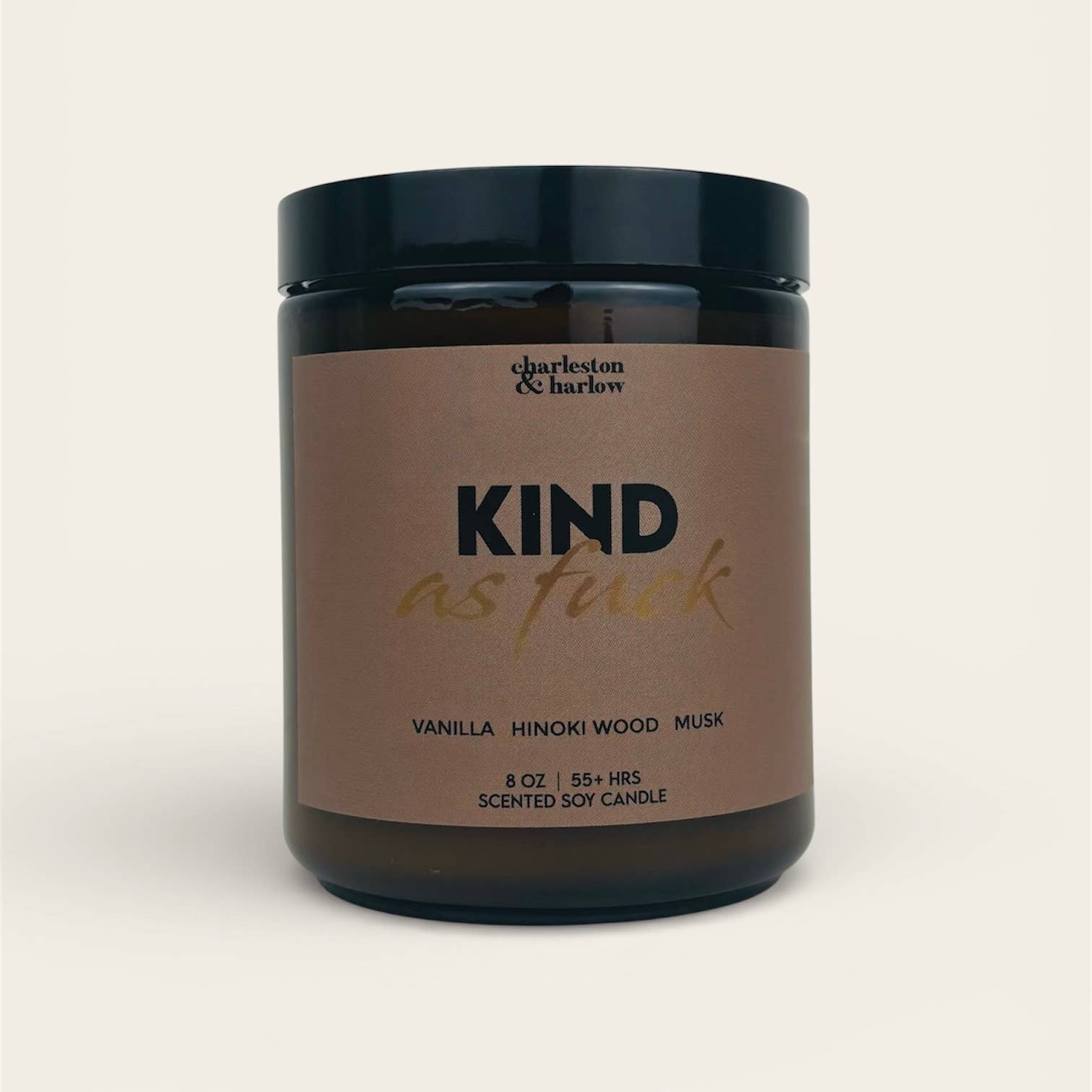 Charleston & Harlow Kind As Fuck soy candle in amber glass jar with warm brown label and gold script