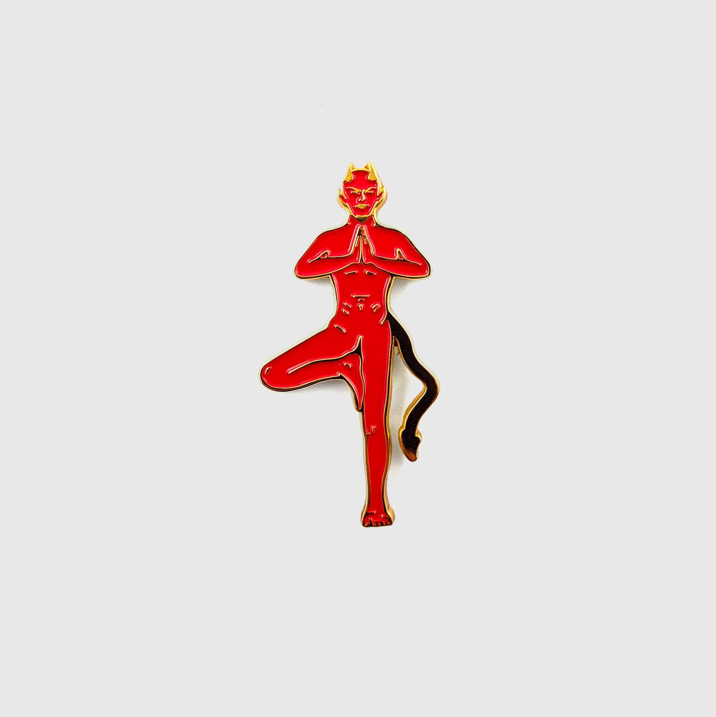 Red enamel pin of a devil figure in tree pose with horns and tail - PABOOM