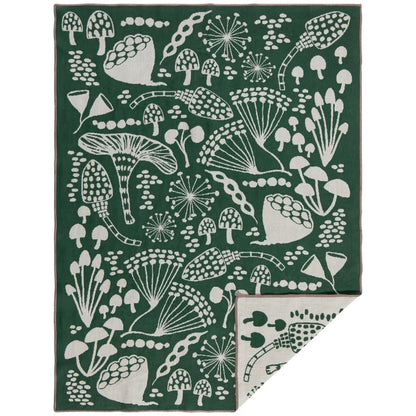 Forest green cotton dishtowel with a cream mushroom and botanical print, folded to show a mirrored reverse panel – PABOOM