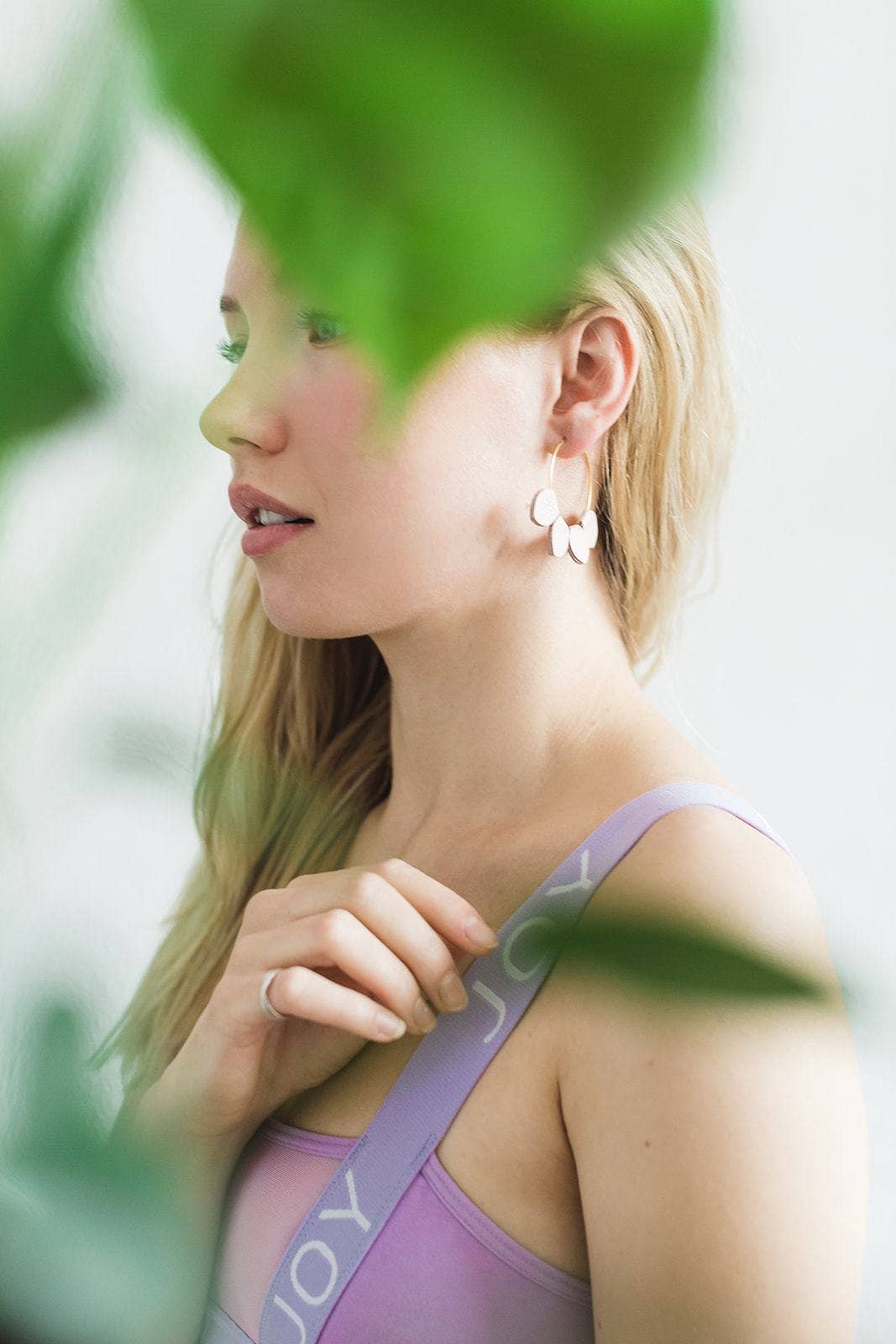 Blush pink leather petal hoop earrings shown in silver, rose gold, and yellow gold finishes