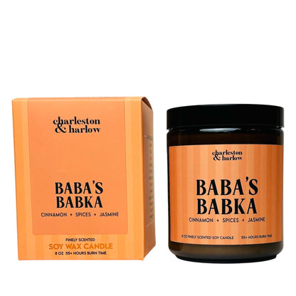 Charleston & Harlow Baba's Babka soy candle in amber jar with orange striped label, beside its matching gift box