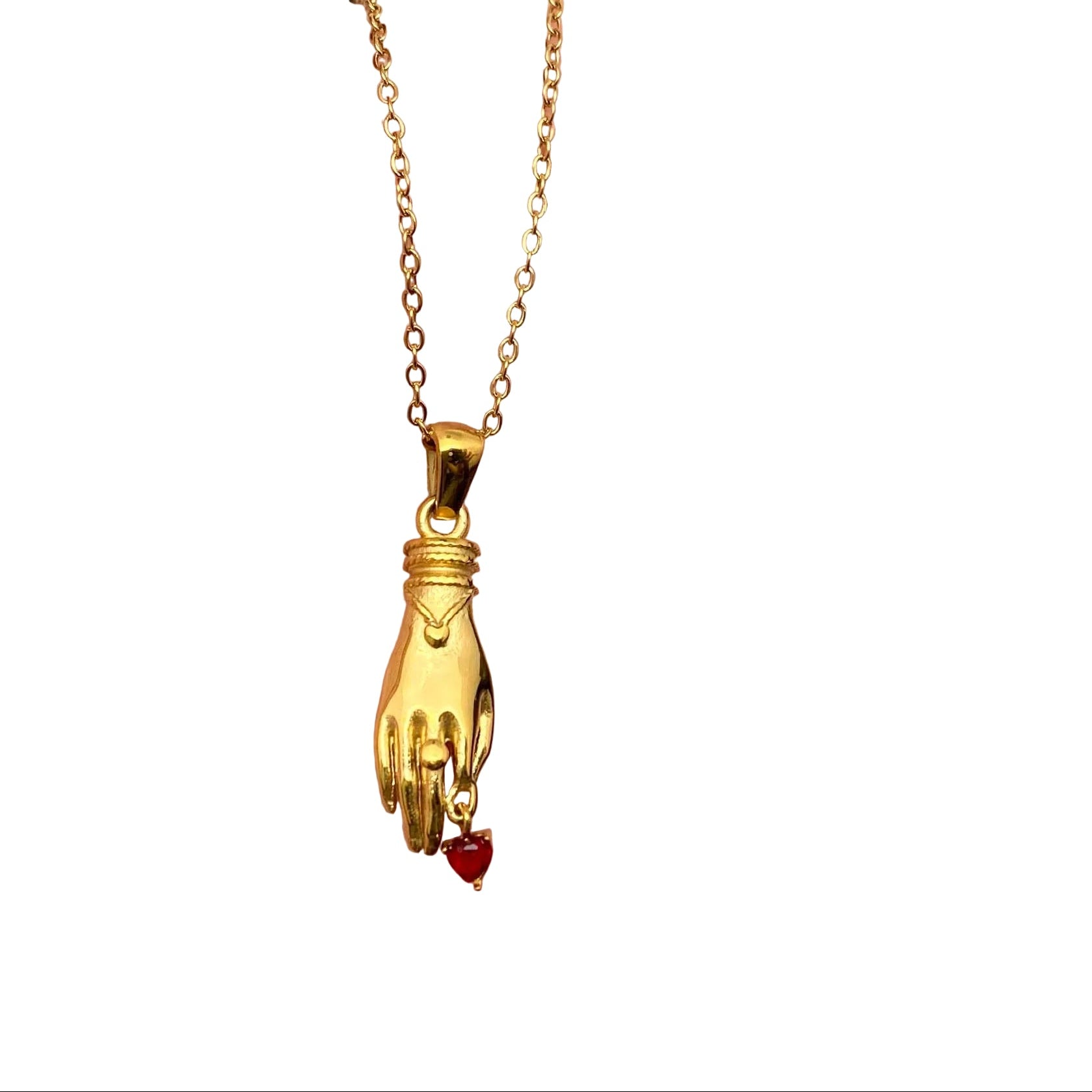 Gold necklace with a hand and heart pendant held in a hand against a white background