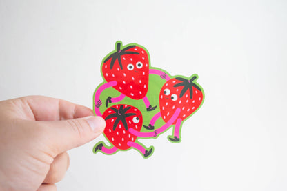 Strawberry Dance Vinyl Sticker — illustration of three strawberry characters with arms and legs holding hands in a circle