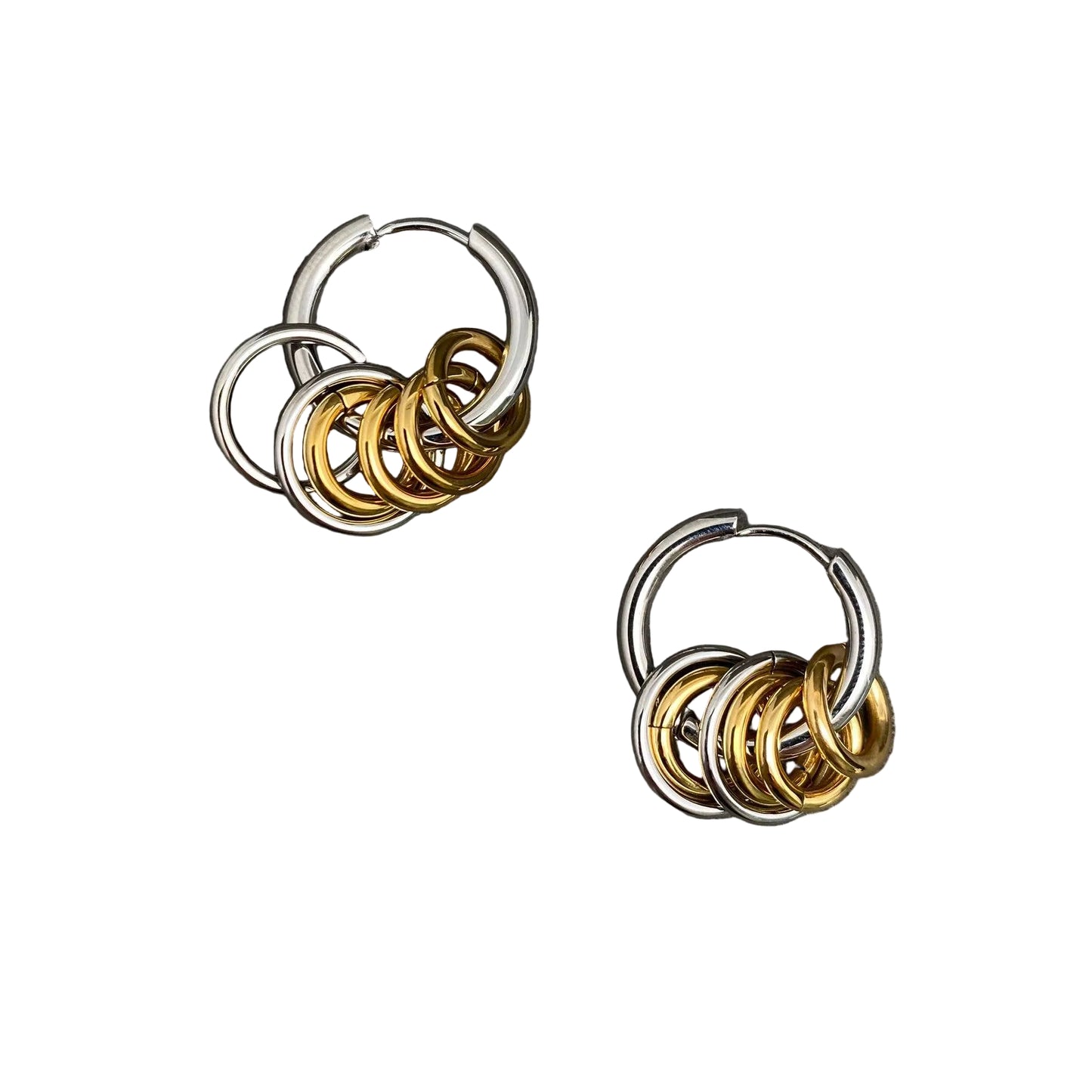 Pair of hoop earrings with interlocking rings in gold and silver on a white background