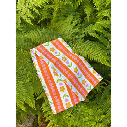 Tulip Stripes Cotton Tea Towel with hand-drawn floral pattern in bright colors – 100% cotton kitchen towel - against ferns - PABOOM