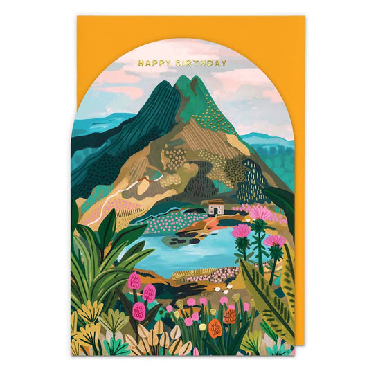 Arched birthday card with green mountain peaks over a turquoise lake and pink wildflowers, gold 'Happy Birthday' text - PABOOM