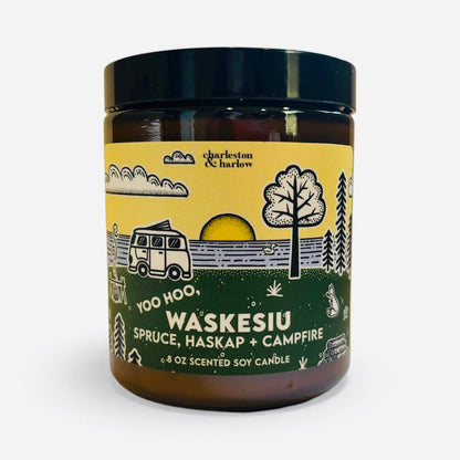 Charleston & Harlow Waskesiu soy candle in amber glass jar with yellow and green label featuring a campervan and lake illustration
