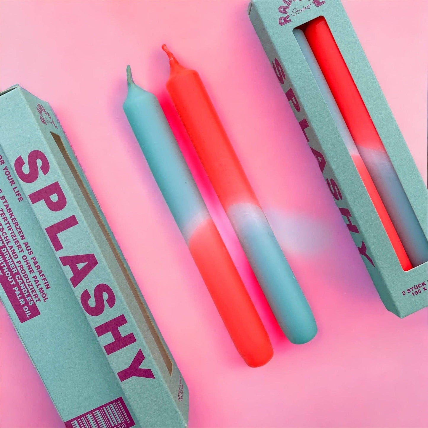 Rainbow Studio Dinner Candle Set Splashy — two dip-dyed taper candles in mint-blue and coral-red gradients, shown with sage green packaging