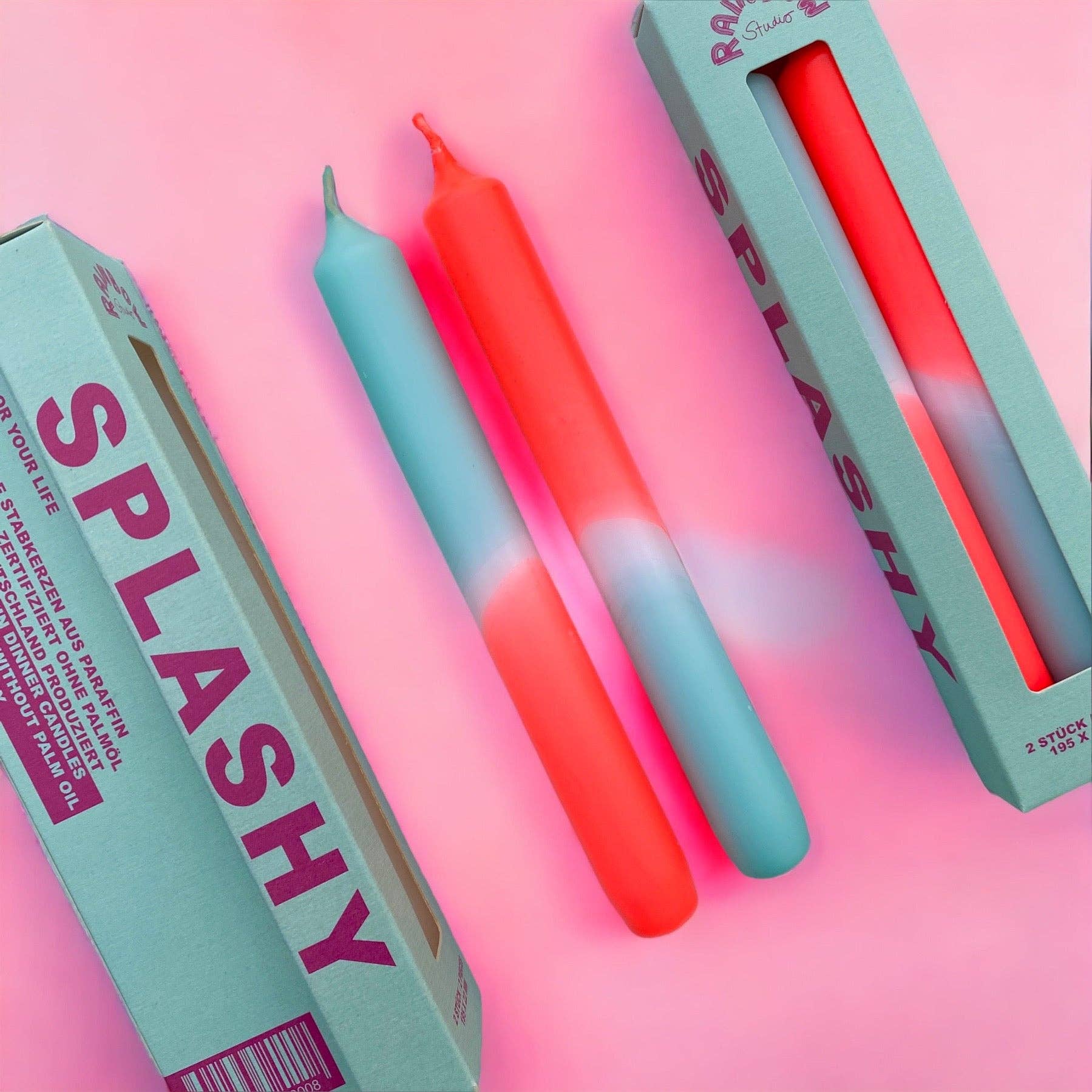 Rainbow Studio Dinner Candle Set Splashy — two dip-dyed taper candles in mint-blue and coral-red gradients, shown with sage green packaging