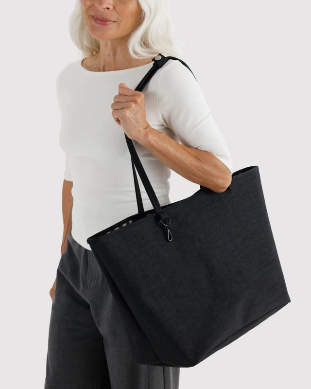 Interior view of the BAGGU Large Nylon Reversible Tote showing the zip pouch and clip leash