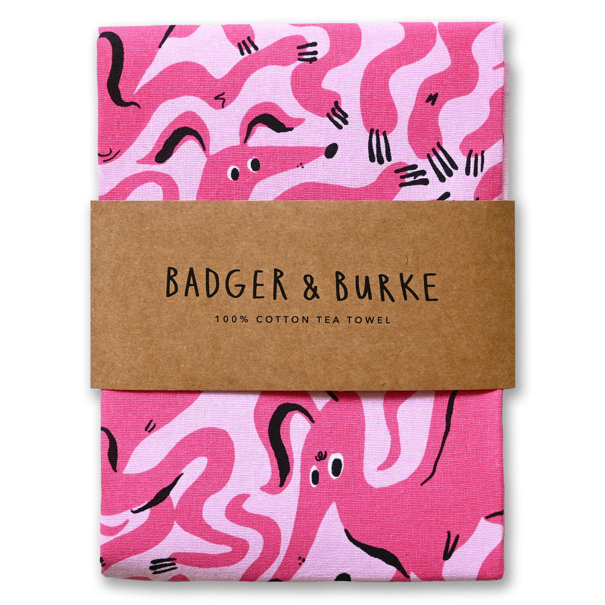 Folded pink cotton tea towel printed with wiggly hot pink dogs, Badger + Burke kraft band - PABOOM