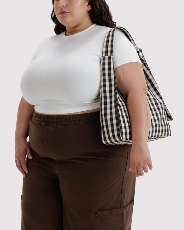 Close-up of the quilted strap and key leash on the BAGGU Nylon Shoulder Bag in black and cream gingham