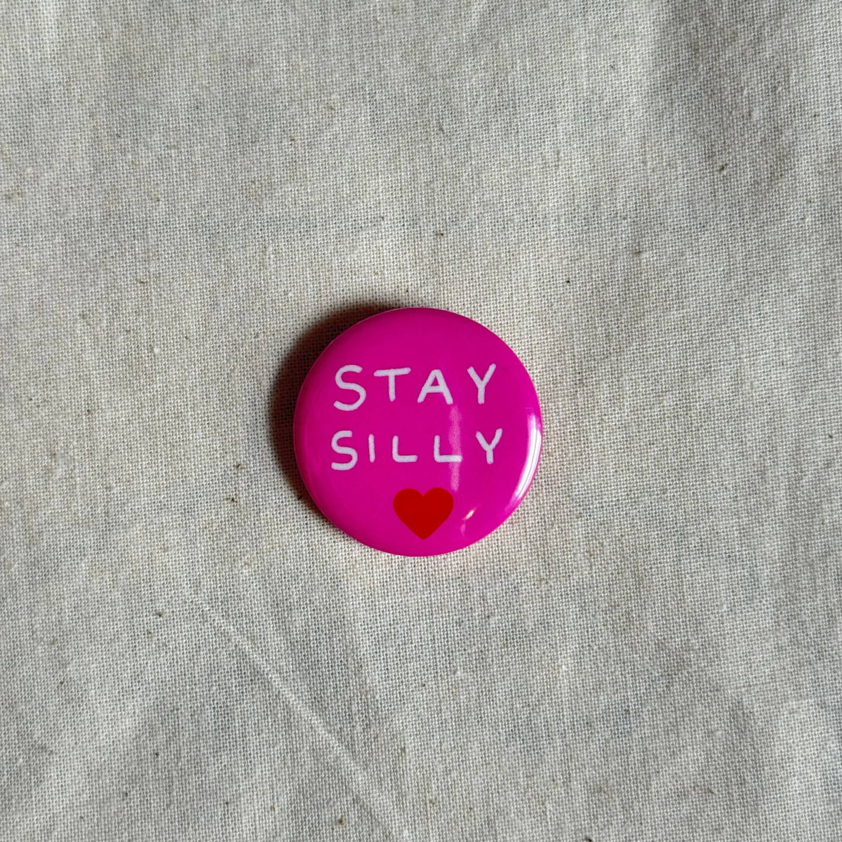Green Stay Silly badge styled flat lay - PABOOM