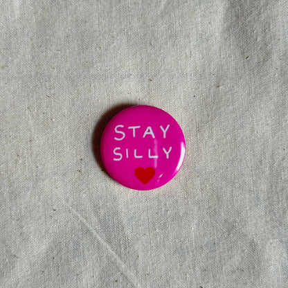 Green Stay Silly badge styled flat lay - PABOOM