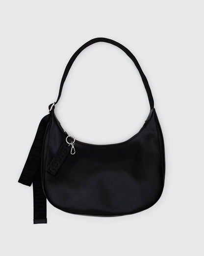 Black BAGGU Medium Recycled Leather Flat Crescent bag with a single adjustable strap, shown against a light grey background