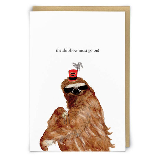 Zeppelinmoon card with a watercolour sloth in sunglasses and a feathered red top hat, text 'the shitshow must go on!' - PABOOM