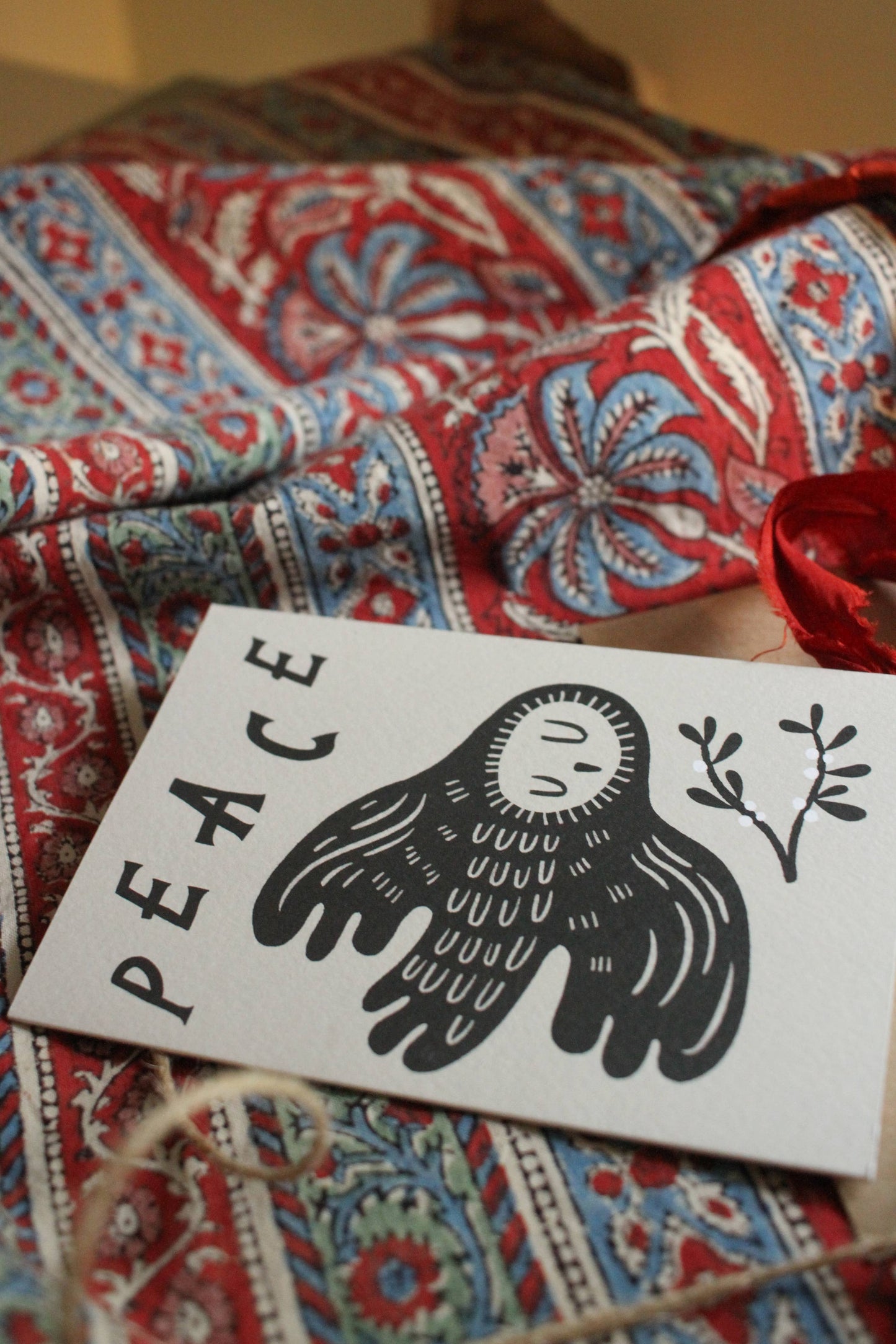 Close-up of the owl illustration and lettering on the 'Peace' Christmas card