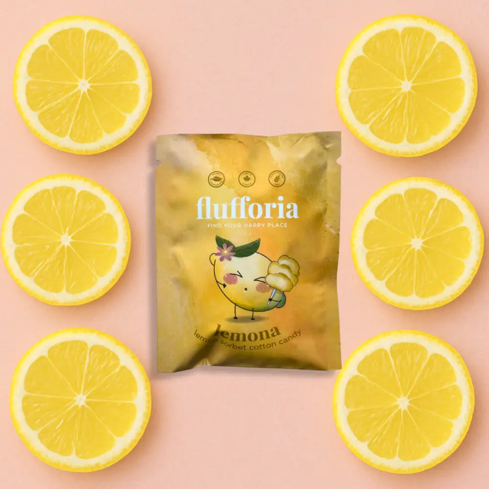 Package of Flufforia’s cotton candy, lemona flavour, yellow package, pink background with lemon slices - PABOOM