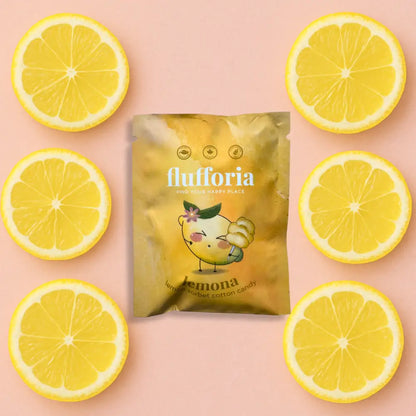 Package of Flufforia’s cotton candy, lemona flavour, yellow package, pink background with lemon slices - PABOOM