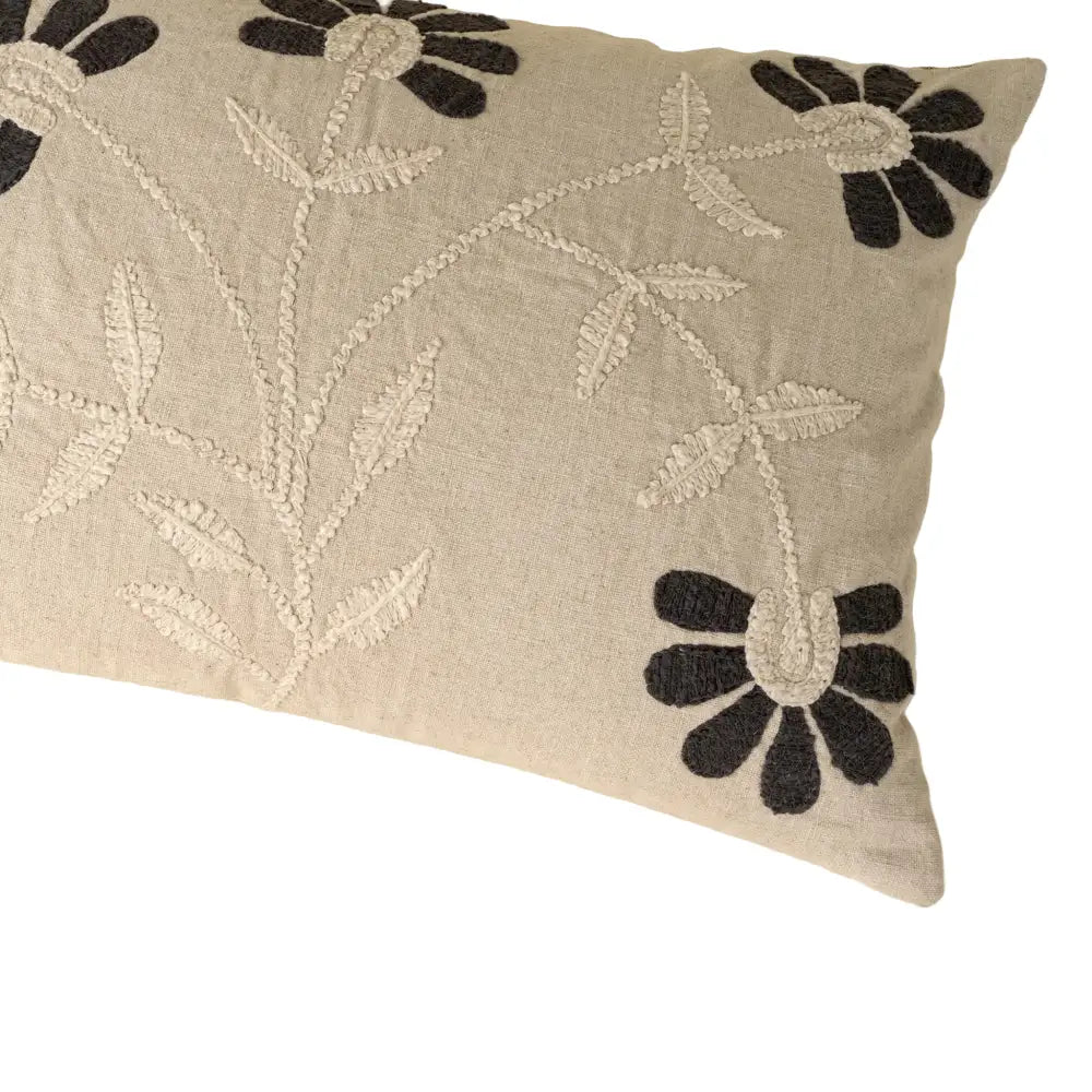 Decorative pillow with floral embroidery on a beige background