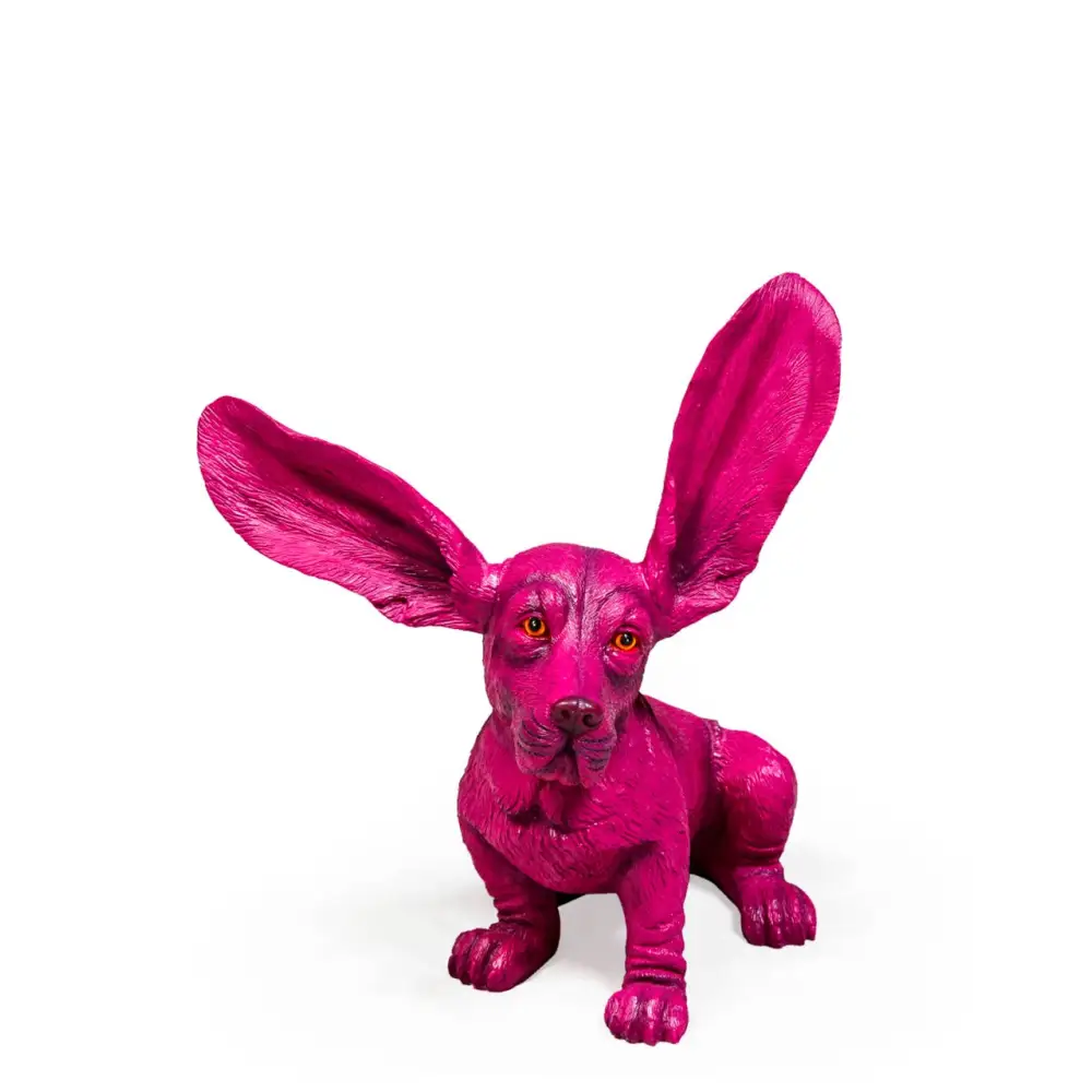 Pink dog figurine with long ears on a white background