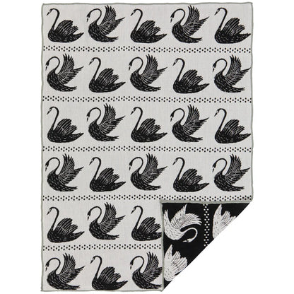 Black-and-white cotton dishtowel with a repeating swan pattern folded to show a black reverse panel – PABOOM
