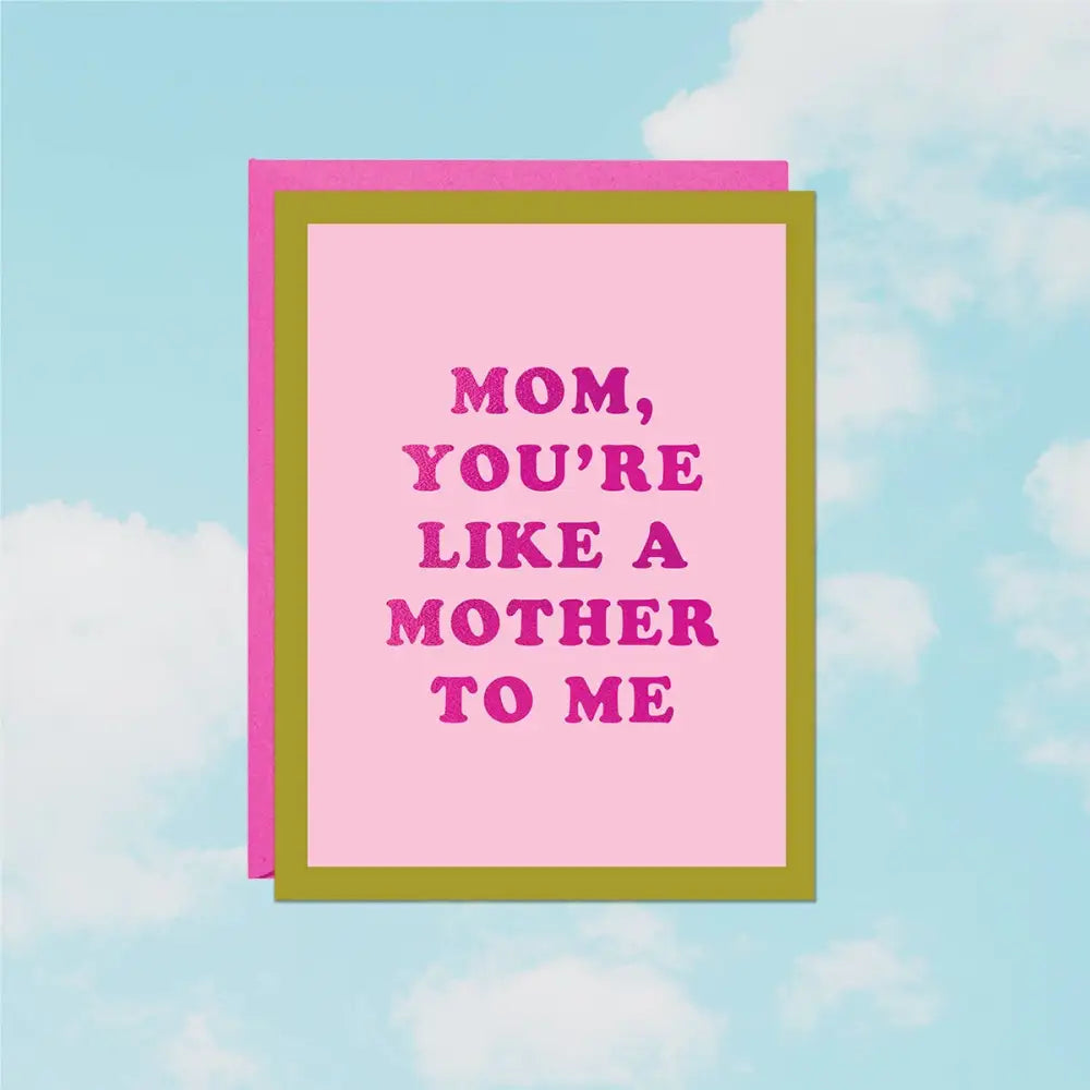 Foil greeting card reading ‘Like a Mother to Me’ on pink cardstock with pink envelope on a cloud background- PABOOM