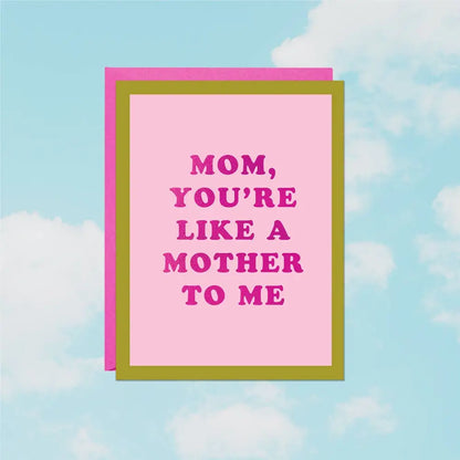 Foil greeting card reading ‘Like a Mother to Me’ on pink cardstock with pink envelope on a cloud background- PABOOM