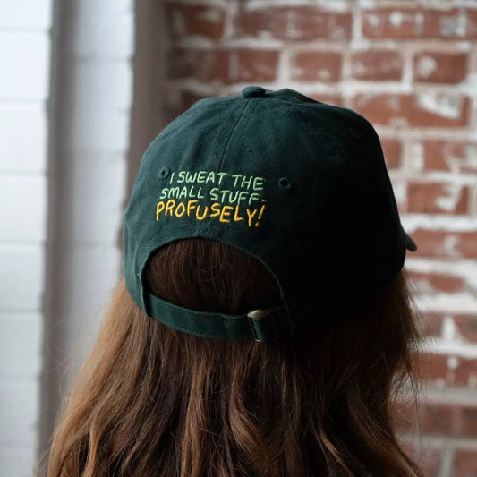 Back of hat with embroidered text "I SWEAT THE SMALL STUFF- PROFUSELY!", green - PABOOM