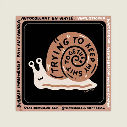 Black vinyl sticker with brown snail with text spiralling in shell “TRYING TO KEEP MY SHIT TOGETHER” by Stay Home Club - PABOOM
