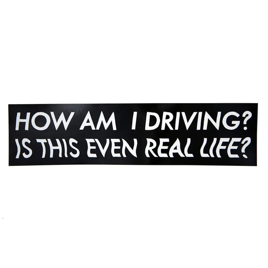 Black bumper sticker with white text "HOW AM I DRIVING?" and wavy white text "IS THIS EVEN REAL LIFE?" - PABOOM