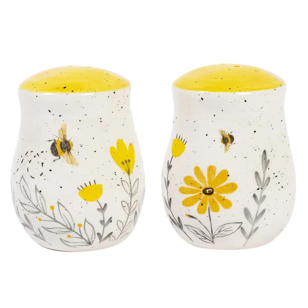 2 Ceramic spice shakers with a floral and bee design with yellow top
