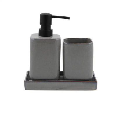 Gray ceramic bathroom set with pump dispenser and cup on a white background