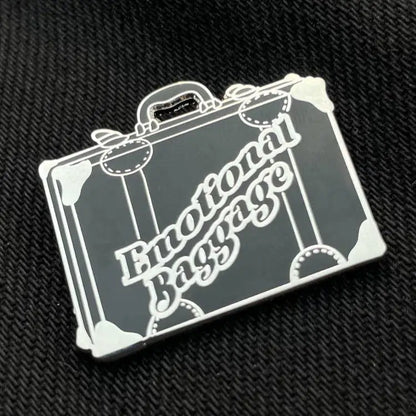 Emotional Baggage Old Suitcase Enamel Pin on black fabric