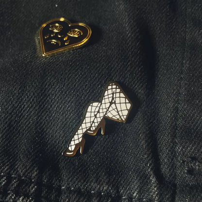 A pair of legs lapel pin on fabric